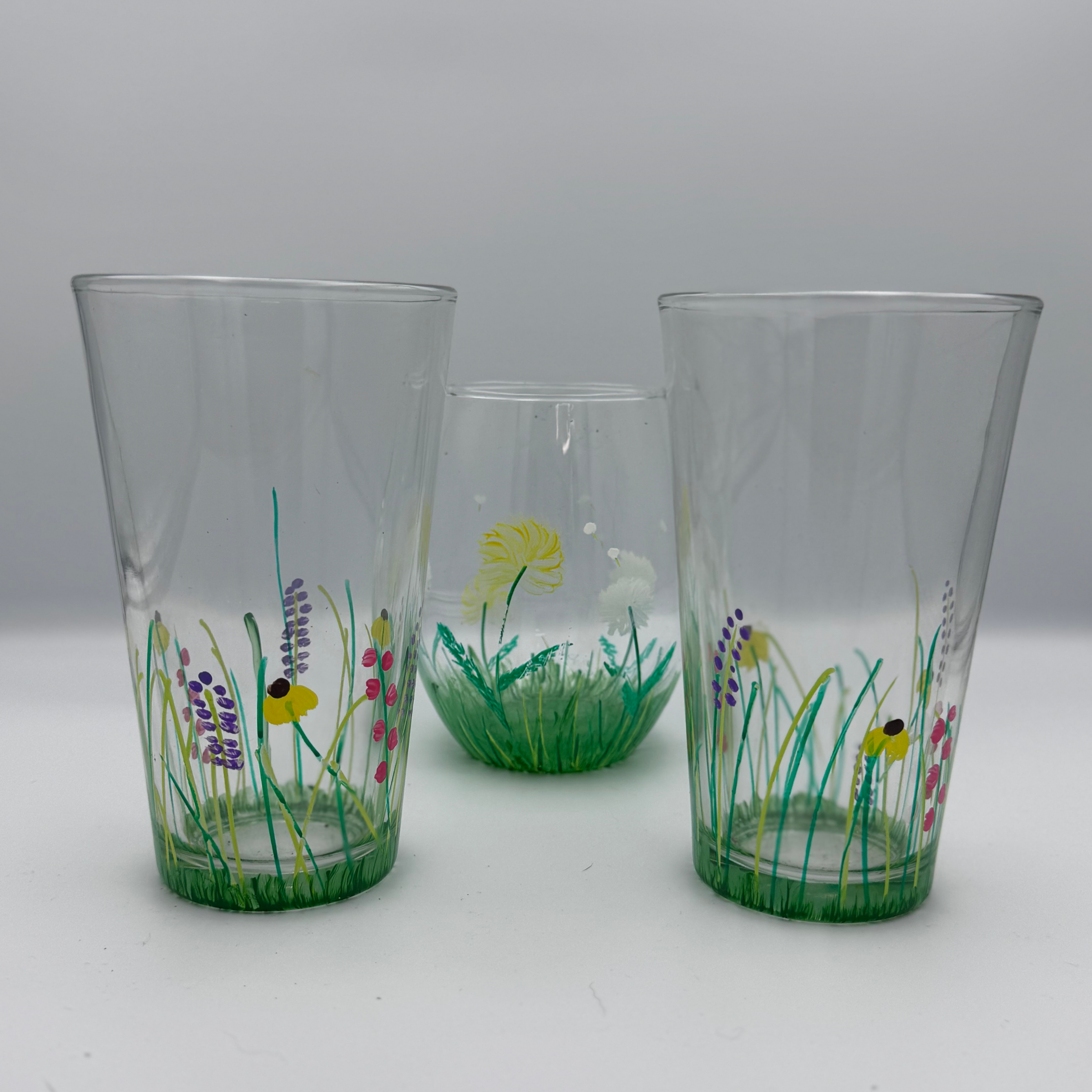 hand painted pint glasses with wildflower meadow design including bees green grass and colorful flowers