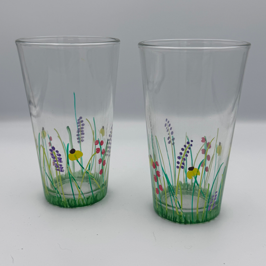 hand painted pint glasses with wildflower meadow design including bees green grass and colorful flowers